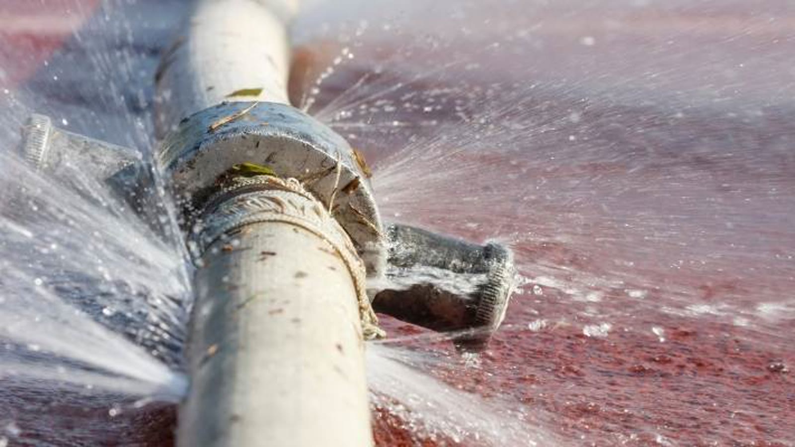 Water spraying from a leaking residential pipe fitting